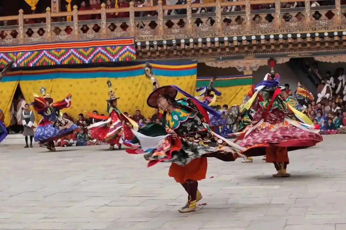 Traditional Bhutanese architecture in Paro Valley with mountain backdrop during cultural tour
